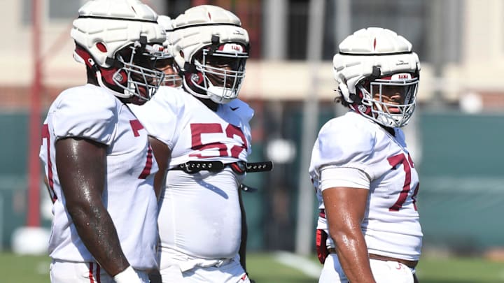 The Crimson Tide players and coaches continue working toward the season opener in practice Tuesday, Aug. 13, 2024. Alabama offensive lineman Jaeden Roberts (77), Alabama offensive lineman Tyler Booker (52) and Alabama offensive lineman Parker Brailsford (72) wait to run a drill.