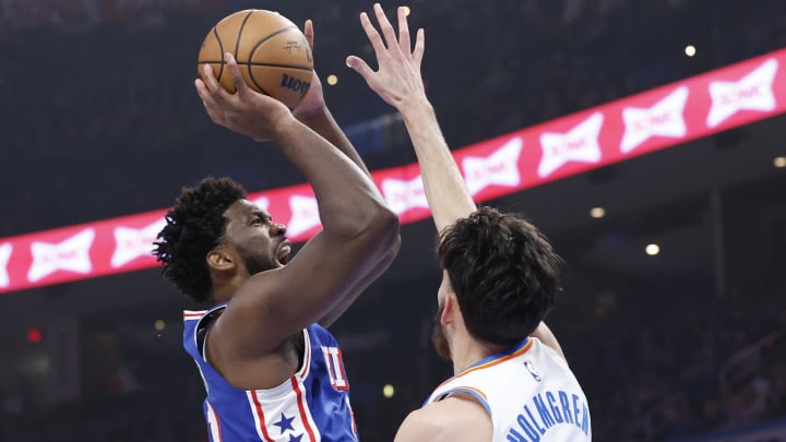 Nov 25, 2023; Oklahoma City, Oklahoma, USA; Philadelphia 76ers center Joel Embiid (21) shoots as Oklahoma City Thunder forward Chet Holmgren (7) defends during the first quarter at Paycom Center. Mandatory Credit: Alonzo Adams-USA TODAY Sports