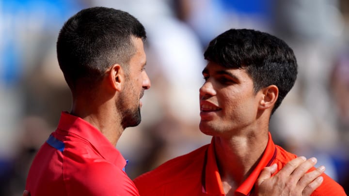 Aug 4, 2024; Paris, France; Novak Djokovic (SRB) greets Carlos Alcaraz (ESP) after winning the men’s singles gold medal match during the Paris 2024 Olympic Summer Games at Stade Roland Garros. 