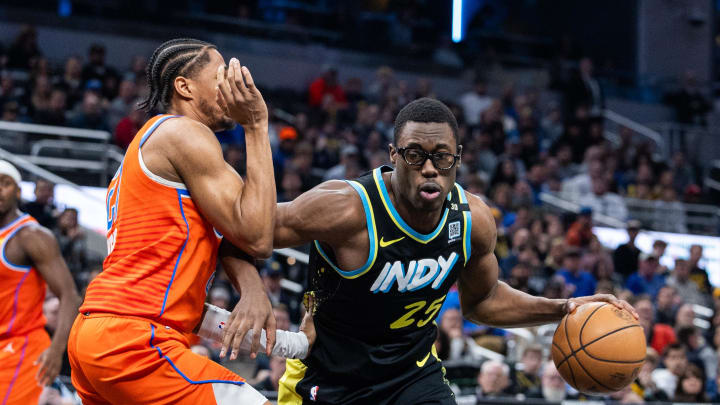Apr 5, 2024; Indianapolis, Indiana, USA; Indiana Pacers forward Jalen Smith (25) dribbles the ball while Oklahoma City Thunder guard Aaron Wiggins (21) defends in the first half at Gainbridge Fieldhouse. Mandatory Credit: Trevor Ruszkowski-USA TODAY Sports