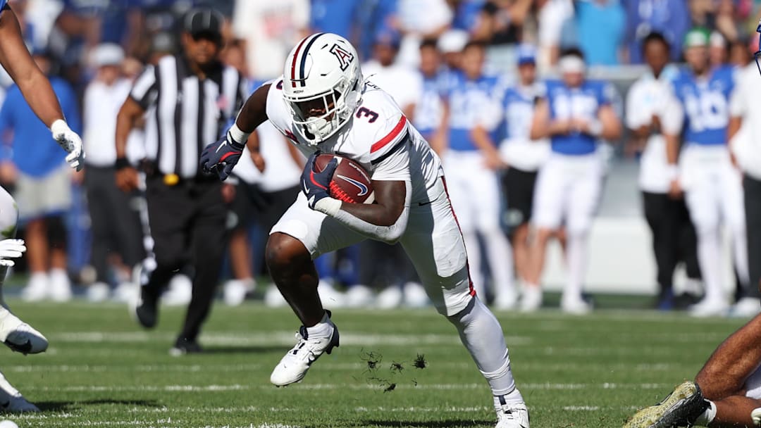 Oct 12, 2024; Provo, Utah, USA; Arizona Wildcats running back Kedrick Reescano (3) runs the ball against the Brigham Young Cougars during the second quarter at LaVell Edwards Stadium.