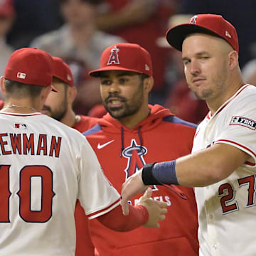 Jun 28, 2025; Anaheim, California, USA;  Los Angeles Angels right fielder Mike Trout (27) greets third baseman Kevin Newman (10) after the final out of the ninth inning defeating the Washington Nationals at Angel Stadium. Mandatory Credit: Jayne Kamin-Oncea-Imagn Images