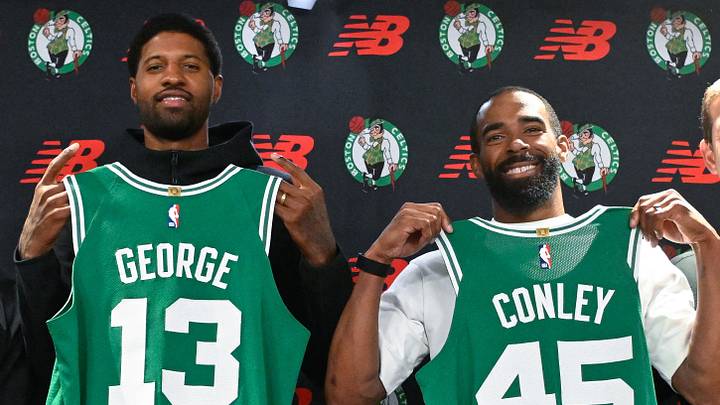September 15, 2026; Boston, Massachusetts, USA; Boston Celtics forward Paul George (13) and Boston Celtics guard Mike Conley (45) pose with their jerseys after a press conference at The Auerbach Center at Boston Landing. Mandatory Credit: Eric Canha-Imagn Images
