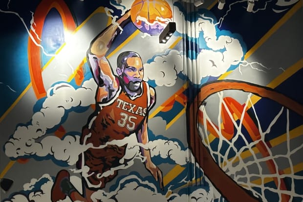 A Kevin Durant mural painted inside Moody Center depicts the NBA star in Burnt Orange threads dunking a basketball.