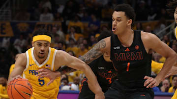 Feb 15, 2025; Pittsburgh, Pennsylvania, USA; Pittsburgh Panthers guard Ishmael Leggett (5) dribbles the ball against Miami (Fl) Hurricanes center Lynn Kidd (1) during the first half at the Petersen Events Center. Mandatory Credit: Charles LeClaire-Imagn Images