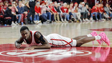 Feb 22, 2025; Norman, Oklahoma, USA; Oklahoma Sooners guard Duke Miles (15) lays on the floor after breaking off teeth during a dive for loose ball with a Mississippi State Bulldogs player during the second half at Lloyd Noble Center. Mandatory Credit: Alonzo Adams-Imagn Images