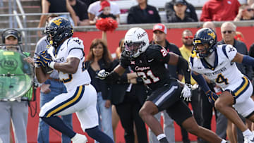 Nov 1, 2025; Houston, Texas, USA; West Virginia Mountaineers running back Cyncir Bowers (23) scores a touchdown against Houston Cougars defensive back Zelmar Vedder (21)  in the first half at TDECU Stadium. Mandatory Credit: Thomas Shea-Imagn Images