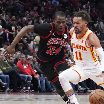 Apr 17, 2024; Chicago, Illinois, USA; Chicago Bulls guard Javonte Green (24) defends Atlanta Hawks guard Trae Young (11) during the second half during a play-in game of the 2024 NBA playoffs at United Center. Mandatory Credit: David Banks-USA TODAY Sports