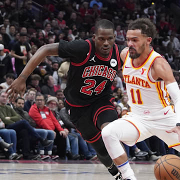 Apr 17, 2024; Chicago, Illinois, USA; Chicago Bulls guard Javonte Green (24) defends Atlanta Hawks guard Trae Young (11) during the second half during a play-in game of the 2024 NBA playoffs at United Center. Mandatory Credit: David Banks-Imagn Images