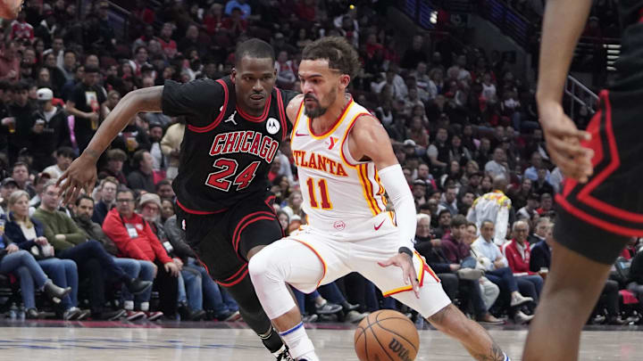 Apr 17, 2024; Chicago, Illinois, USA; Chicago Bulls guard Javonte Green (24) defends Atlanta Hawks guard Trae Young (11) during the second half during a play-in game of the 2024 NBA playoffs at United Center. Mandatory Credit: David Banks-Imagn Images