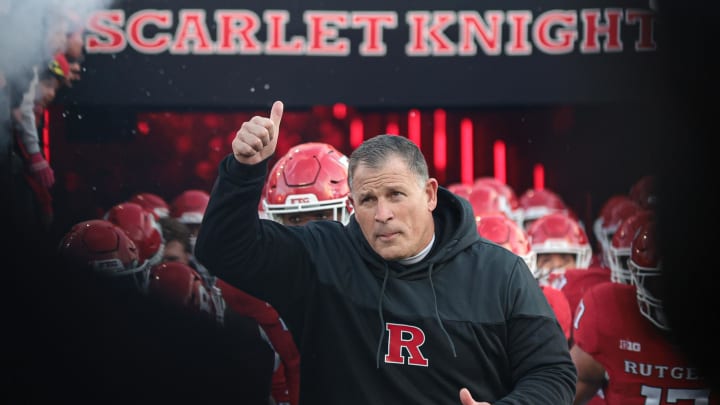 Rutgers Scarlet Knights head coach Greg Schiano runs onto the field with his team before a game against Maryland.