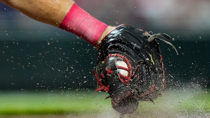 Cincinnati Reds catcher Tyler Stephenson squeezes a pitch in the dirt in the eighth inning of the MLB interleague game between the Cincinnati Reds and the Minnesota Twins. Cincinnati Reds catcher Tyler Stephenson squeezes a pitch in the dirt in the eighth inning of the MLB interleague game between the Cincinnati Reds and the Minnesota Twins.