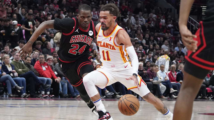 Apr 17, 2024; Chicago, Illinois, USA; Chicago Bulls guard Javonte Green (24) defends Atlanta Hawks guard Trae Young (11) during the second half during a play-in game of the 2024 NBA playoffs at United Center. Mandatory Credit: David Banks-Imagn Images