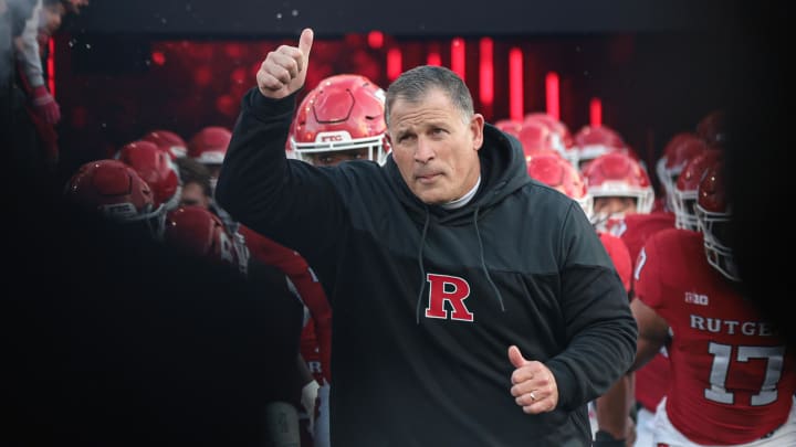 Rutgers Scarlet Knights head coach Greg Schiano runs out to the field 