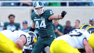 Oct 25, 2014; East Lansing, MI, USA; Michigan State Spartans defensive end Marcus Rush (44) looks over Michigan Wolverines ofensive line during the 2nd half of a game at Spartan Stadium.  MSU won 35-11. Mandatory Credit: Mike Carter-Imagn Images