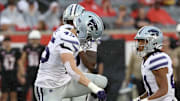 Nov 2, 2024; Houston, Texas, USA; Kansas State Wildcats linebacker Austin Romaine (45) steps over Houston Cougars running back J'Marion Burnette (20) after Burnette was tackled for a loss in the first quarter at TDECU Stadium. Mandatory Credit: Thomas B. Shea-Imagn Images