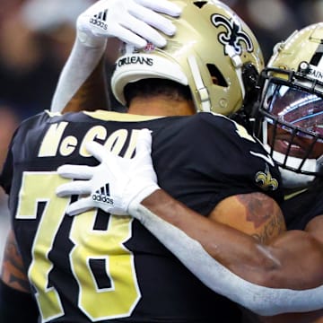 Sep 15, 2024; Arlington, Texas, USA; New Orleans Saints running back Alvin Kamara (41) celebrates with New Orleans Saints center Erik McCoy (78) after scoring a touchdown  during the first quarter against the Dallas Cowboys at AT&T Stadium. Mandatory Credit: Kevin Jairaj-Imagn Images