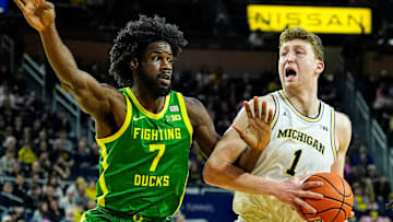 Michigan center Danny Wolf (1) is defended by Oregon forward Supreme Cook (7) during the first half at Crisler Center in Ann Arbor on Wednesday, Feb. 5, 2025.