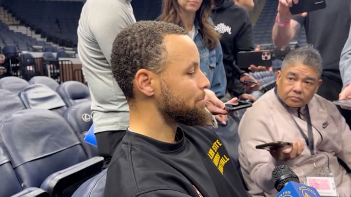 Golden State Warriors guard Steph Curry speaks with reporters.