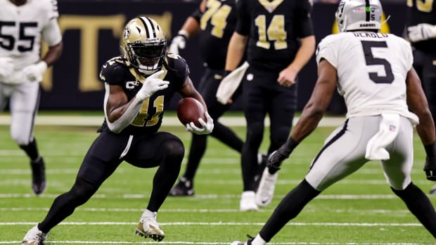 Oct 30, 2022; New Orleans Saints running back Alvin Kamara (41) looks to evade Las Vegas Raiders linebacker Divine Deablo (5)