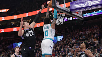 Jan 15, 2025; Salt Lake City, Utah, USA;  Charlotte Hornets forward Miles Bridges (0) dunks against Utah Jazz center Walker Kessler (24) during the second quarter at Delta Center. Mandatory Credit: Chris Nicoll-Imagn Images