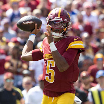 Sep 15, 2024; Landover, Maryland, USA; Washington Commanders quarterback Jayden Daniels (5) drops back tin th first quarter agaistn the New York Giants at Commanders Field. Mandatory Credit: Luke Johnson-Imagn Images

