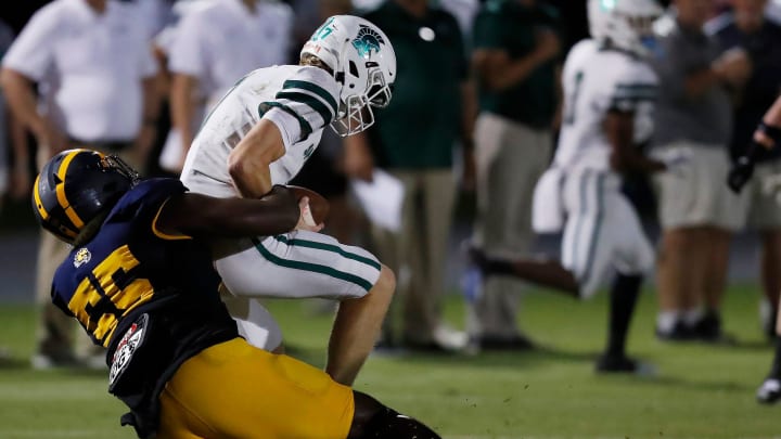 Prince Avenue's Christian Garrett (55) sacks Athens Academy's Hampton Johnson (7) during a GHSA high school football game in Bogart, Ga., on Friday, Sept. 1, 2023.