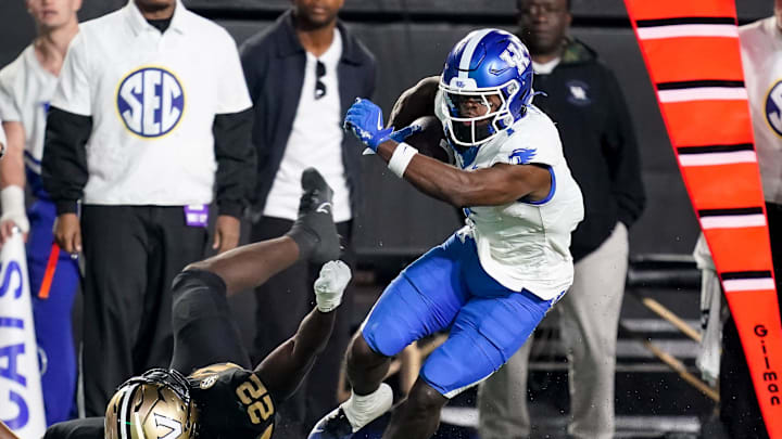 Kentucky wide receiver Kendrick Law (1) slips past Vanderbilt linebacker Bryce Cowan (22) during the fourth quarter at FirstBank Stadium in Nashville, Tenn., Saturday, Nov. 22, 2025.