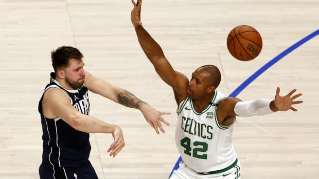 Jun 12, 2024; Dallas, Texas, USA; Dallas Mavericks guard Luka Doncic (77) passes against Boston Celtics center Al Horford (42) during the fourth quarter in game three of the 2024 NBA Finals at American Airlines Center. Mandatory Credit: Peter Casey-USA TODAY Sports