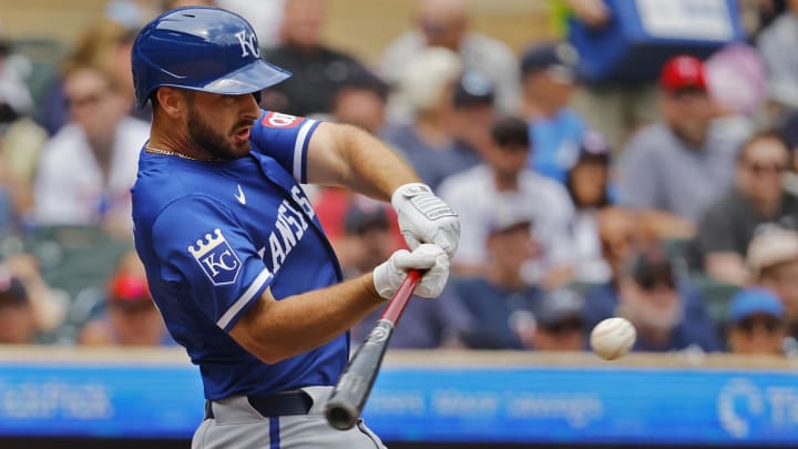 Aug 14, 2024; Minneapolis, Minnesota, USA; Kansas City Royals third baseman Paul DeJong hits a solo home run against the Minnesota Twins in the sixth inning at Target Field. Mandatory Credit: Bruce Kluckhohn-USA TODAY Sports