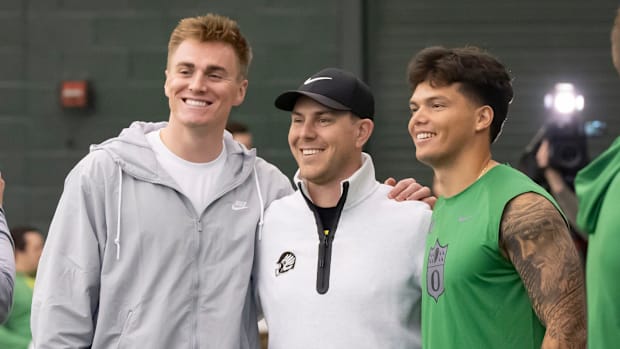 Denver Broncos quarterback Bo Nix, a former Oregon quarterback, left, and Oregon quarterback Dillon Gabriel, right, take a pi