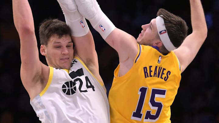 Feb 10, 2025; Los Angeles, California, USA; Los Angeles Lakers guard Austin Reaves (15) defends a shot by Utah Jazz center Walker Kessler (24) in the second half at Crypto.com Arena. Mandatory Credit: Jayne Kamin-Oncea-Imagn Images