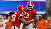 Aug 31, 2024; Atlanta, Georgia, USA; Georgia Bulldogs defensive lineman Mykel Williams (13) celebrates after a tackle with linebacker Chaz Chambliss (32) against the Clemson Tigers in the third quarter at Mercedes-Benz Stadium. Mandatory Credit: Brett Davis-Imagn Images