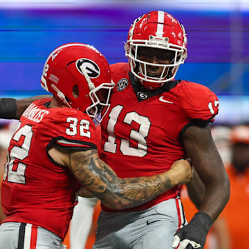 Aug 31, 2024; Atlanta, Georgia, USA; Georgia Bulldogs defensive lineman Mykel Williams (13) celebrates after a tackle with linebacker Chaz Chambliss (32) against the Clemson Tigers in the third quarter at Mercedes-Benz Stadium. Mandatory Credit: Brett Davis-Imagn Images