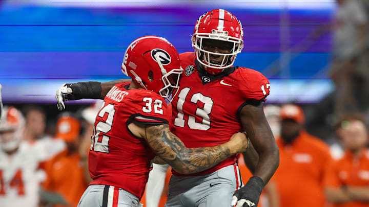 Aug 31, 2024; Atlanta, Georgia, USA; Georgia Bulldogs defensive lineman Mykel Williams (13) celebrates after a tackle with linebacker Chaz Chambliss (32) against the Clemson Tigers in the third quarter at Mercedes-Benz Stadium. Mandatory Credit: Brett Davis-Imagn Images