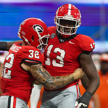 Aug 31, 2024; Atlanta, Georgia, USA; Georgia Bulldogs defensive lineman Mykel Williams (13) celebrates after a tackle with linebacker Chaz Chambliss (32) against the Clemson Tigers in the third quarter at Mercedes-Benz Stadium. Mandatory Credit: Brett Davis-Imagn Images