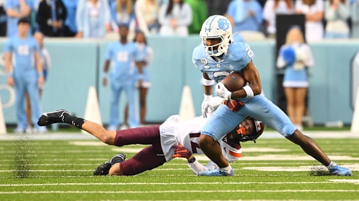 Oct 1, 2022; Chapel Hill, North Carolina, USA; North Carolina Tar Heels wide receiver Gavin Blackwell (2) with the ball as Virginia Tech Hokies defensive back Cam Johnson (12) defends in the fourth quarter at Kenan Memorial Stadium. Mandatory Credit: Bob Donnan-Imagn Images