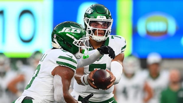 New York Jets quarterback Justin Fields hands off to running back Braelon Allen