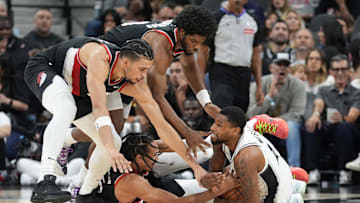 Nov 7, 2024; San Antonio, Texas, USA;  Portland Trail Blazers forward Toumani Camara (33) and guards Scoot Henderson (00) and Dalano Banton (5) surround San Antonio Spurs guard Blake Wesley (14) for a loose ball in the second half at Frost Bank Center. Mandatory Credit: Daniel Dunn-Imagn Images