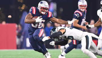 Aug 15, 2024; Foxborough, MA, USA; New England Patriots running back Kevin Harris (36) avoids a tackle by Philadelphia Eagles safety Tristin McCollum (36) during the first half at Gillette Stadium. Mandatory Credit: Eric Canha-USA TODAY Sports