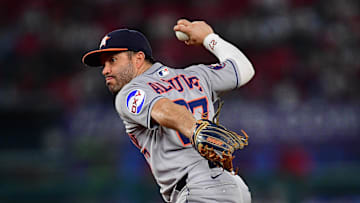 Houston Astros second baseman Jose Altuve (27) throws to first for the out against Los Angeles Angels right fielder Jo Adell (7) during the sixth inning at Angel Stadium.