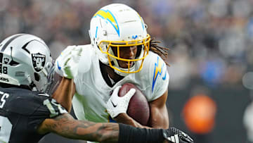 Jan 5, 2025; Paradise, Nevada, USA; Las Vegas Raiders cornerback Jack Jones (18) looks to tackle Los Angeles Chargers wide receiver Quentin Johnston (1) during the second quarter at Allegiant Stadium. Mandatory Credit: Stephen R. Sylvanie-Imagn Images