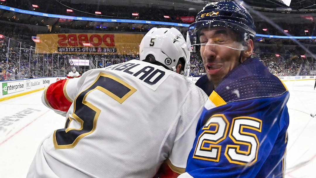 Jan 9, 2024; St. Louis, Missouri, USA;  Florida Panthers defenseman Aaron Ekblad (5) checks St. Louis Blues center Jordan Kyrou (25) during the second period at Enterprise Center. Mandatory Credit: Jeff Curry-Imagn Images