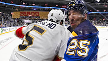 Jan 9, 2024; St. Louis, Missouri, USA;  Florida Panthers defenseman Aaron Ekblad (5) checks St. Louis Blues center Jordan Kyrou (25) during the second period at Enterprise Center. Mandatory Credit: Jeff Curry-Imagn Images