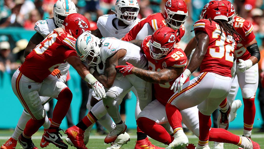 Sep 27, 2026; Miami Gardens, Florida, USA;  Kansas City Chiefs defensive line Peter Woods (99) tackles Miami Dolphins running back Ollie Gordon II (0) during the second quarter at Hard Rock Stadium.  Mandatory Credit: Nathan Ray Seebeck-Imagn Images