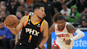 Oct 30, 2022; Phoenix, Arizona, USA; Phoenix Suns guard Devin Booker (1) dribbles against Houston Rockets guard Jalen Green (4) during the second half at Footprint Center. Mandatory Credit: Joe Camporeale-Imagn Images