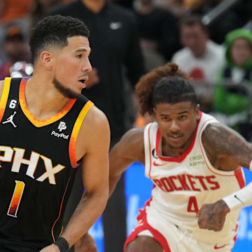 Oct 30, 2022; Phoenix, Arizona, USA; Phoenix Suns guard Devin Booker (1) dribbles against Houston Rockets guard Jalen Green (4) during the second half at Footprint Center. Mandatory Credit: Joe Camporeale-Imagn Images