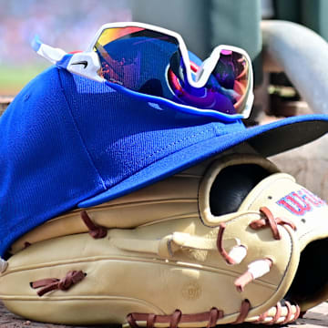 Feb 27, 2024; Mesa, Arizona, USA;  General view of a Chicago Cubs glove, hat and glasses in the first inning against the Cincinnati Reds during a spring training game at Sloan Park. 