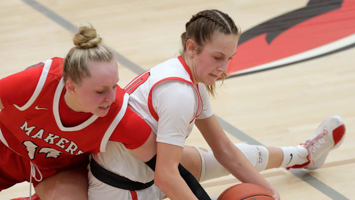 Kimberly High School's Ava Van Vonderen (34) scrambles for a loose ball against Neenah High School's Izzy Malloy (10) during their girls basketball game Thursday, February 19, 2026, at Neenah High School in Fox Crossing, Wisconsin. Kimberly won 64-50.