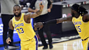 Jan 25, 2021; Cleveland, Ohio, USA; Los Angeles Lakers forward LeBron James (23) celebrates his three-point basket with center Montrezl Harrell (15) in the first quarter against the Cleveland Cavaliers at Rocket Mortgage FieldHouse. Mandatory Credit: David Richard-Imagn Images